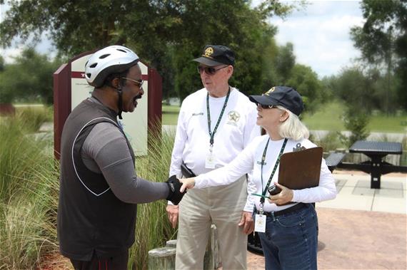 volunteers shaking hands with citizen